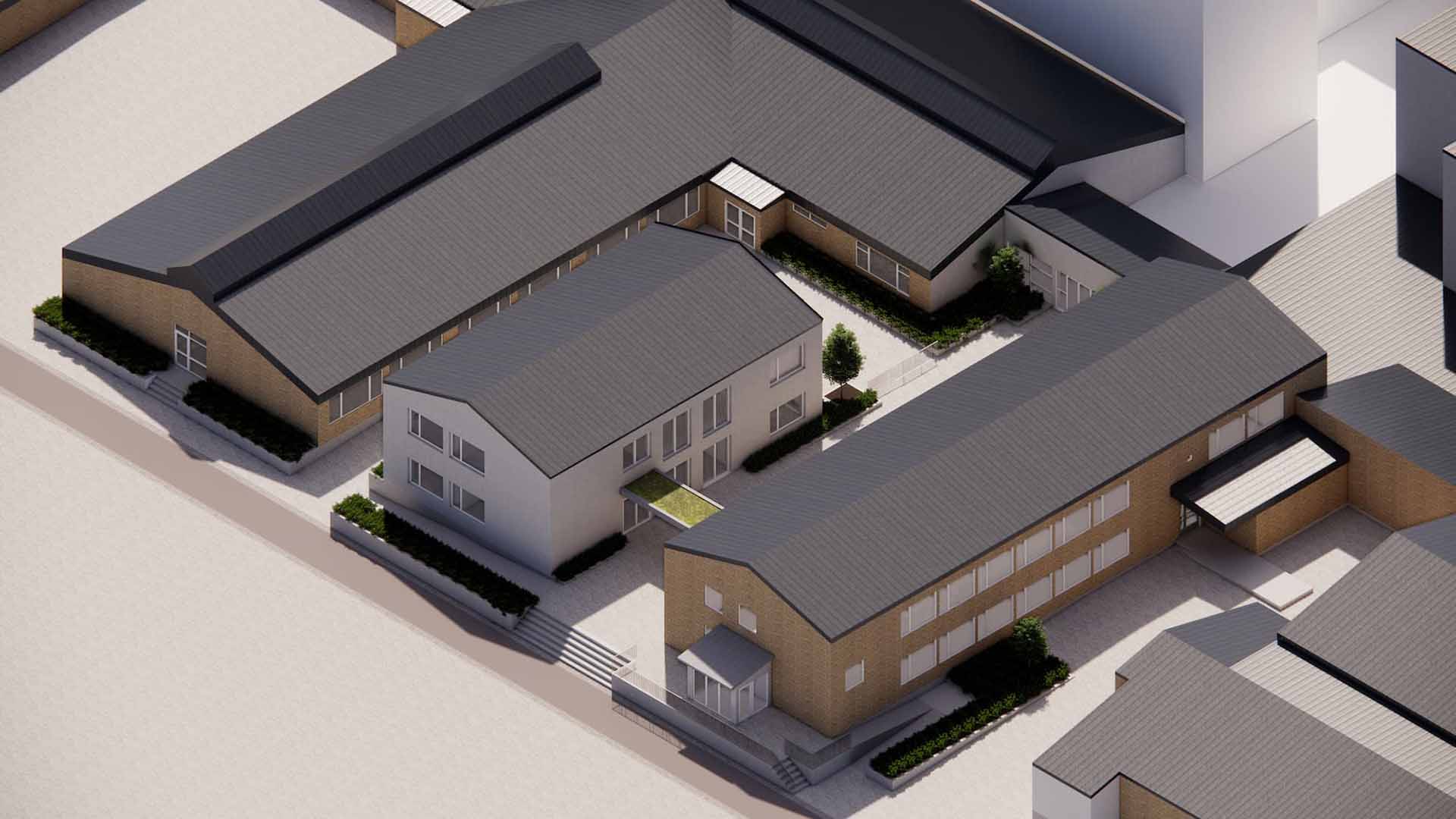 Översikt ovanifrån som visar gymnasiets nya byggnad, bland andra hus.